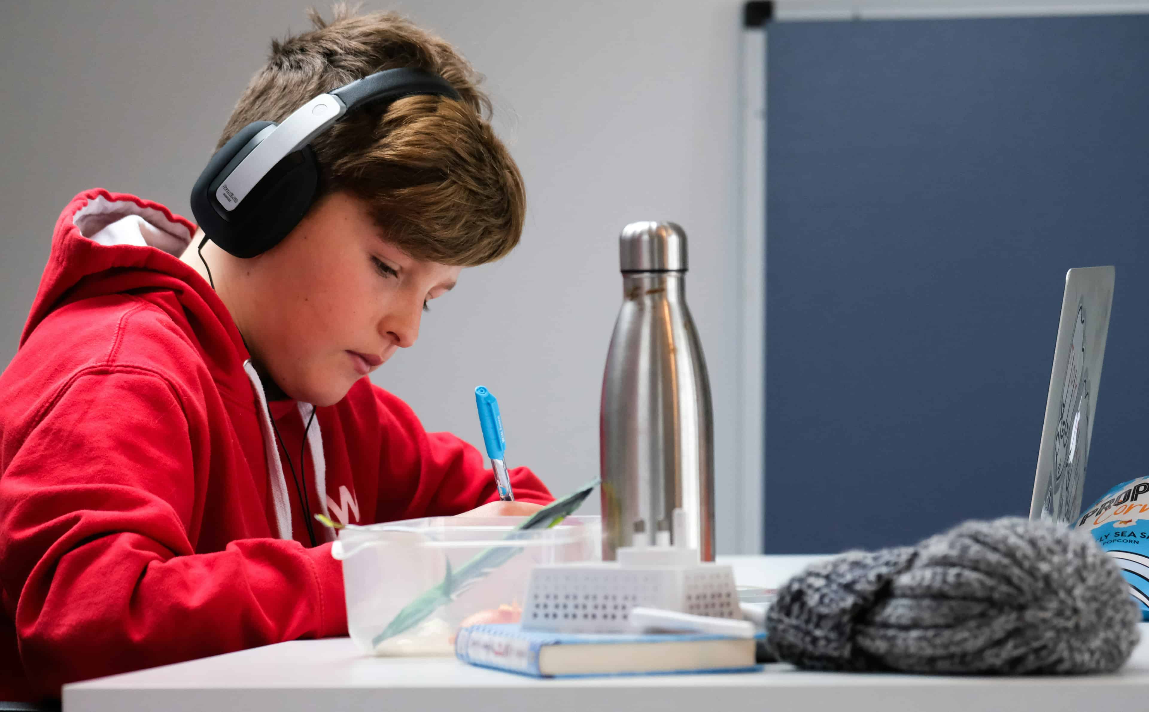 boy working on school work with laptop