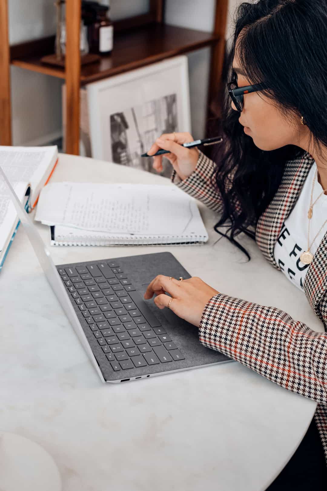 A young student focused on her laptop while doing homework, representing independent learning facilitated by The Study Corner.